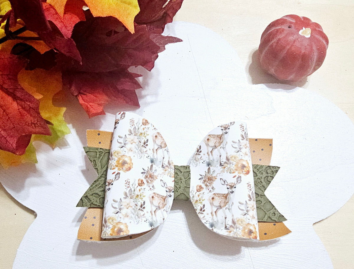 Handmade Oh Deer faux leather boutique hair bow featuring a woodland deer and floral design with fall colors.