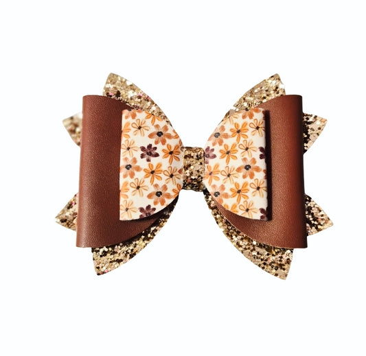 Handmade medium faux leather fall floral boutique hair bow with brown and gold glitter accents for babies, toddlers, and girls.