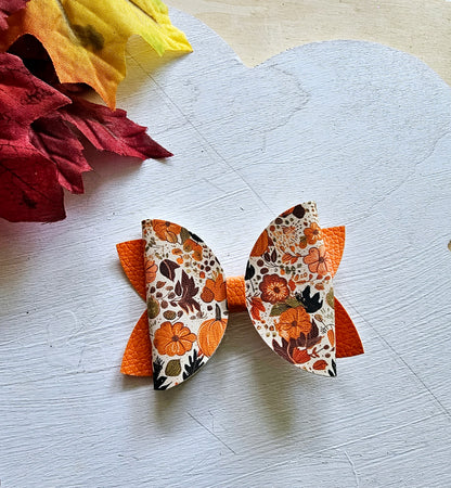 Handmade fall hair accessory set featuring one small faux leather boutique hair bow with four matching autumn snap clips for babies, toddlers, and girls.