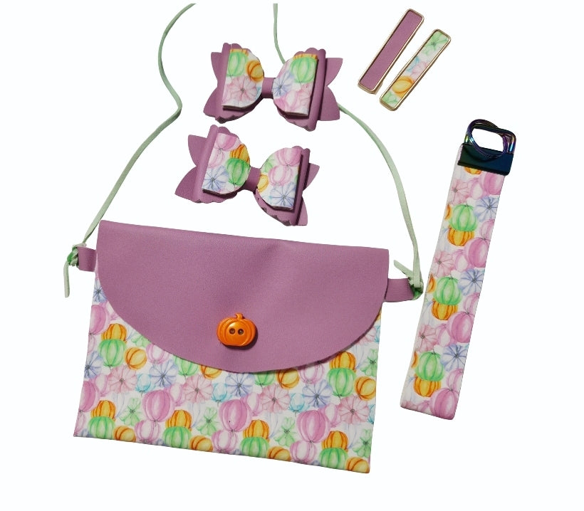 Handmade girls fall pumpkin purse set featuring a faux leather crossbody purse, matching boutique hair bows, lip balm holder, and keychain.