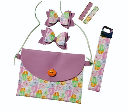Handmade girls fall pumpkin purse set featuring a faux leather crossbody purse, matching boutique hair bows, lip balm holder, and keychain.