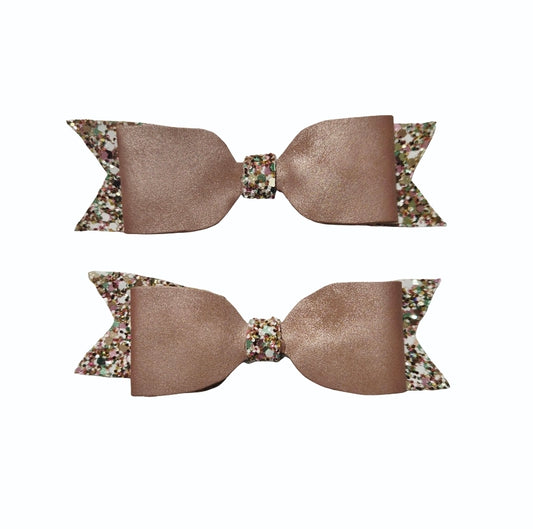 Handmade 2-pack rose gold faux leather boutique hair bows with glitter accents for babies, toddlers, and girls.