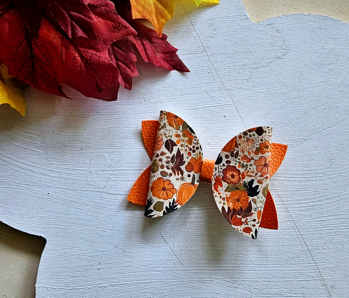 Handmade fall hair accessory set featuring one small faux leather boutique hair bow with four matching autumn snap clips for babies, toddlers, and girls.