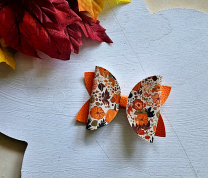 Handmade fall hair accessory set featuring one small faux leather boutique hair bow with four matching autumn snap clips for babies, toddlers, and girls.