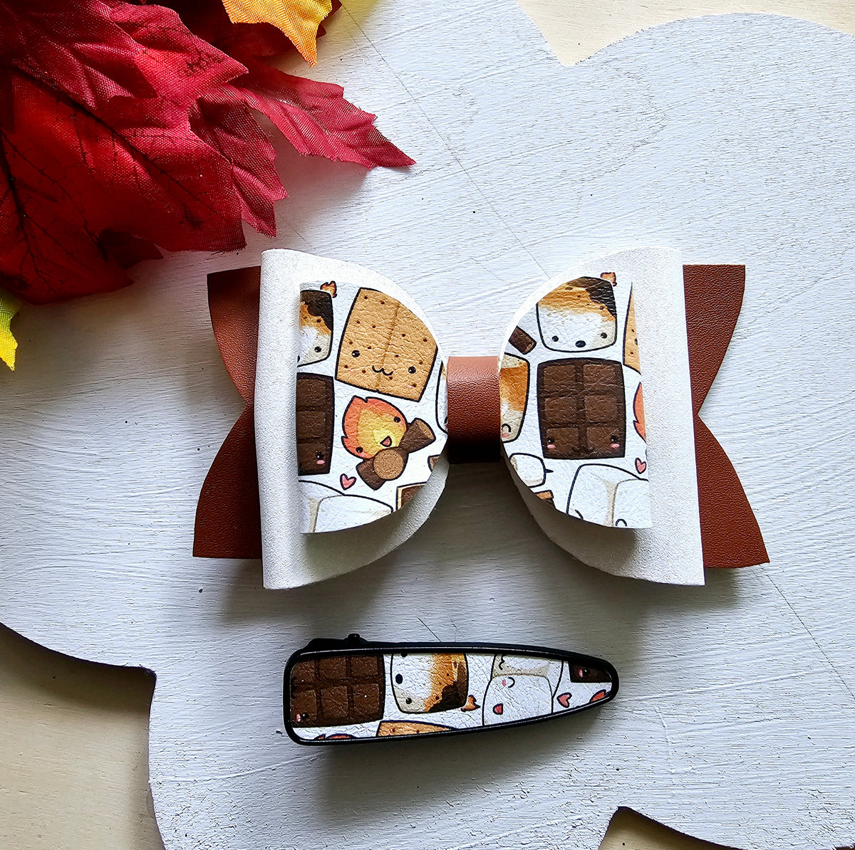 Handmade Sweet S'mores faux leather hair bow with matching snap clip featuring a cozy campfire marshmallow print for babies, toddlers, and girls.