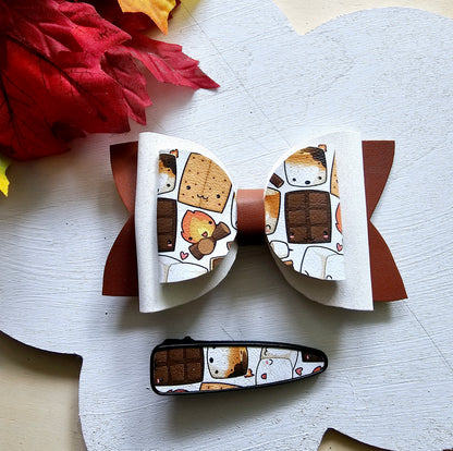 Handmade Sweet S'mores faux leather hair bow with matching snap clip featuring a cozy campfire marshmallow print for babies, toddlers, and girls.