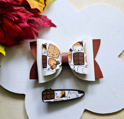 Handmade Sweet S'mores faux leather hair bow with matching snap clip featuring a cozy campfire marshmallow print for babies, toddlers, and girls.