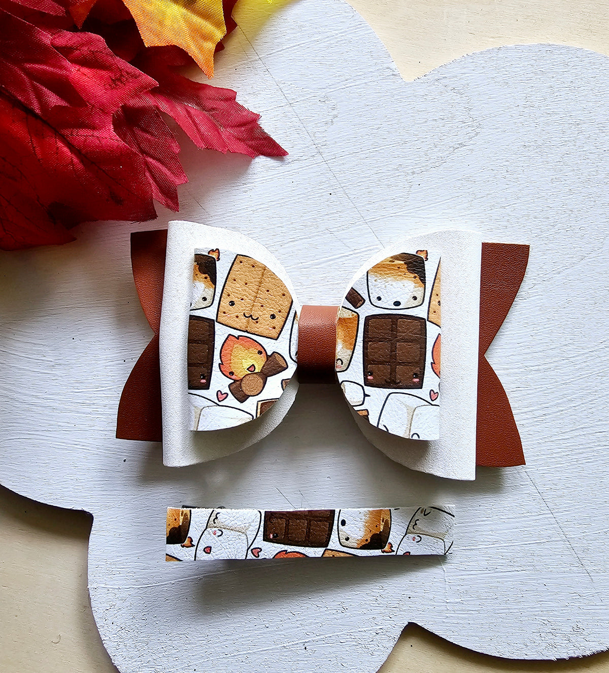 Handmade Sweet S'mores faux leather hair bow with matching snap clip featuring a cozy campfire marshmallow print for babies, toddlers, and girls.