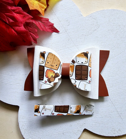Handmade Sweet S'mores faux leather hair bow with matching snap clip featuring a cozy campfire marshmallow print for babies, toddlers, and girls.