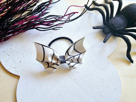 Handmade bat ponytail holder made with faux leather for girls' Halloween hairstyles.