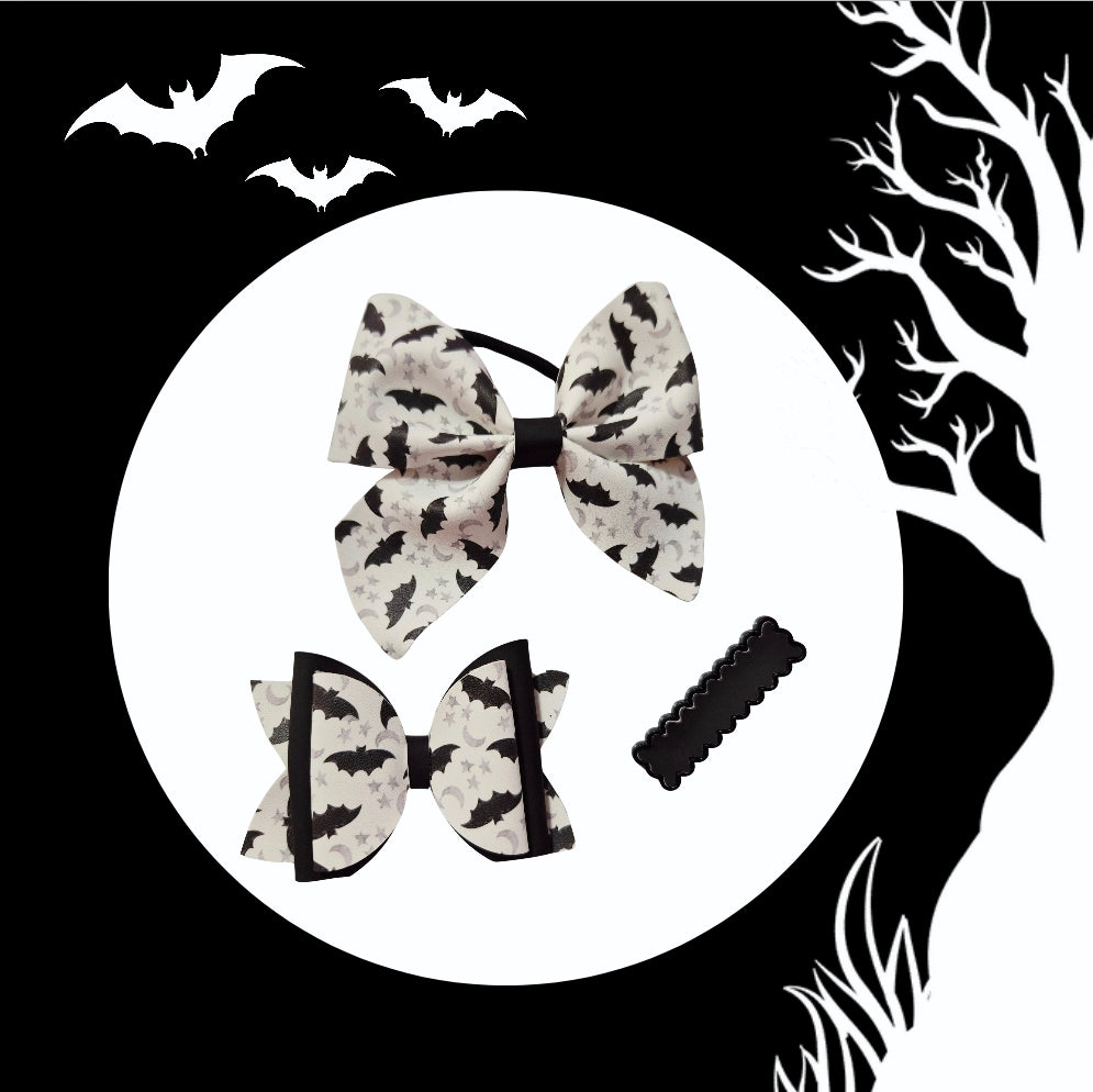 Heat-changing Bat Senses Halloween hair accessory set with medium ponytail holder, mini hair bow, and matching hair clip.