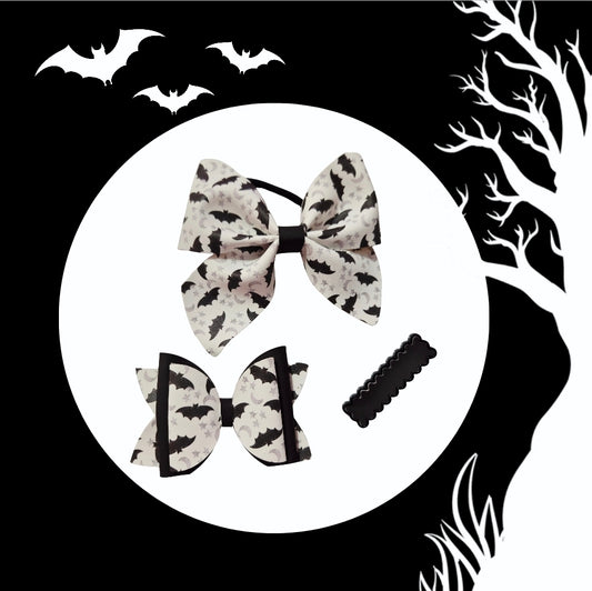 Heat-changing Bat Senses Halloween hair accessory set with medium ponytail holder, mini hair bow, and matching hair clip.