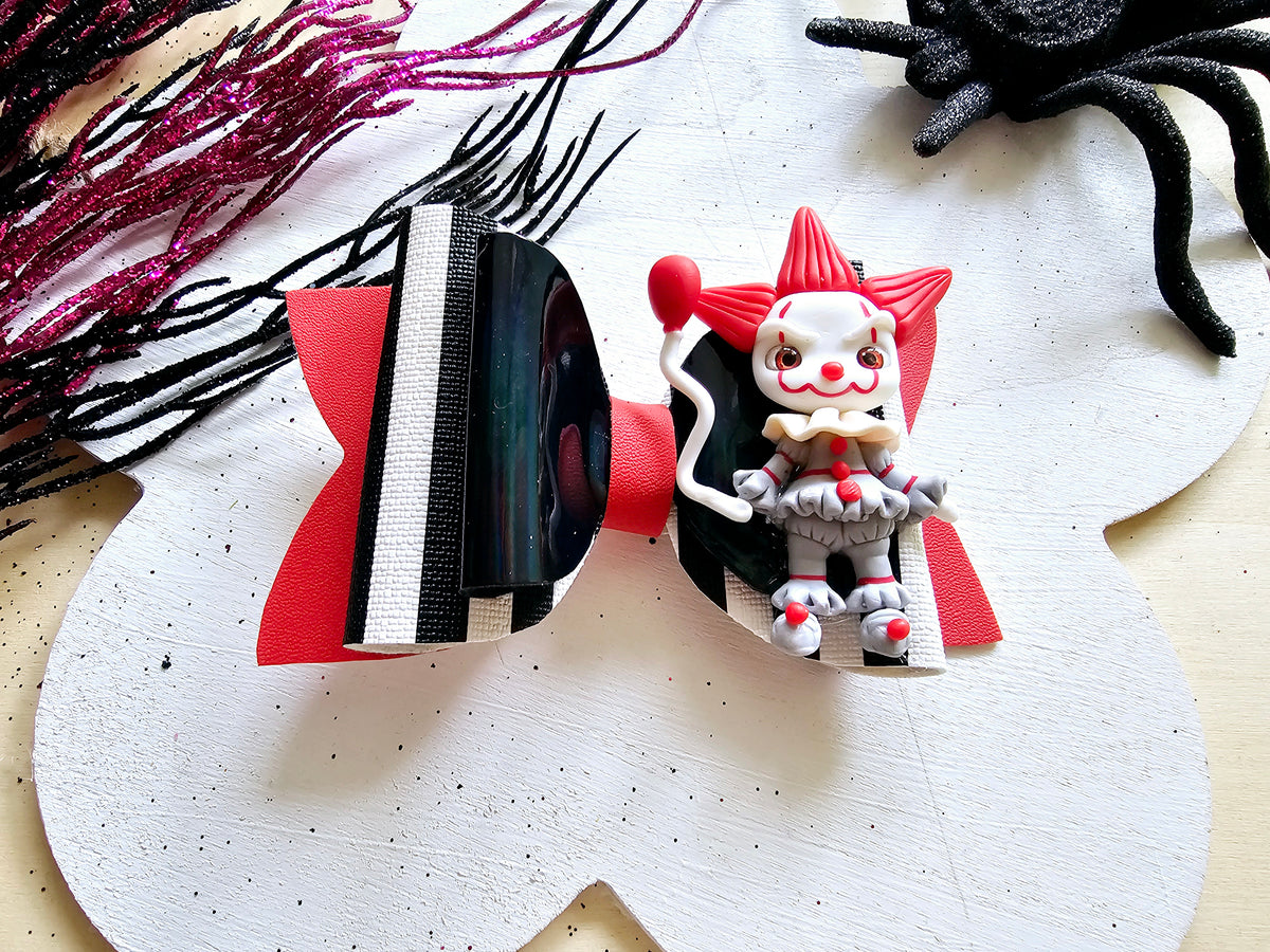 Handmade Scary Clown Halloween hair bow featuring glitter accents and a detailed creepy clown centerpiece for girls.
