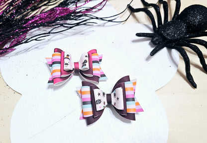 Mini handmade Halloween hair bow featuring heat-changing faux leather, available on an alligator clip or headband.