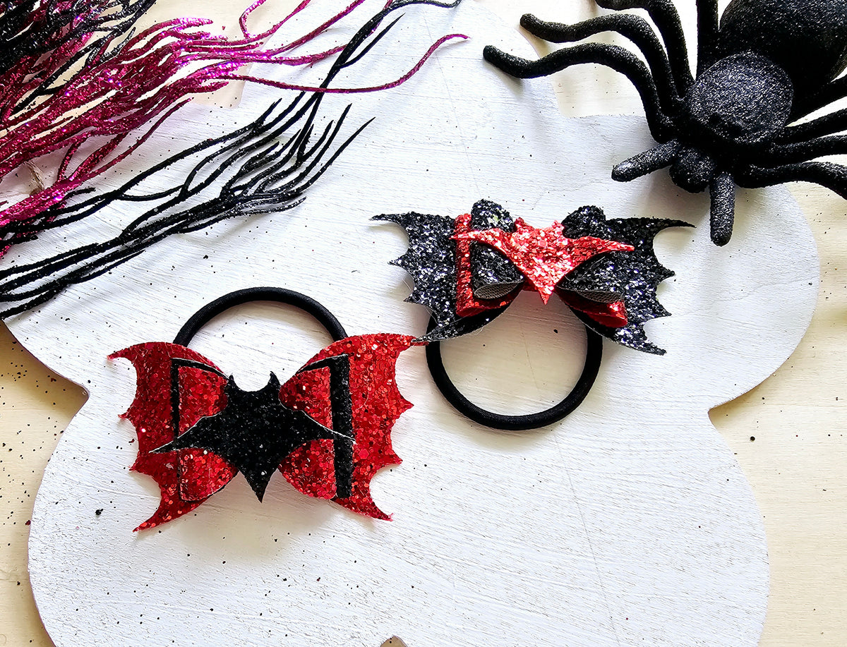 Handmade vampire bat ponytail holder that glows in the dark for spooky season outfits.