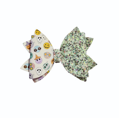 Handmade glow-in-the-dark glitter Halloween hair bow for girls.