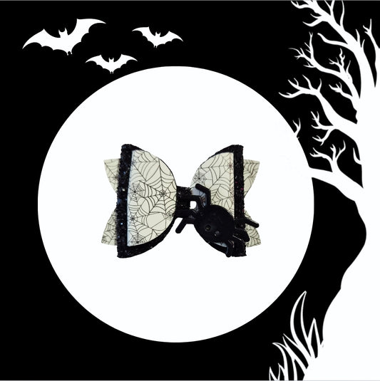 Glow-in-the-dark spider Halloween hair bow handmade for girls with black glitter accents.