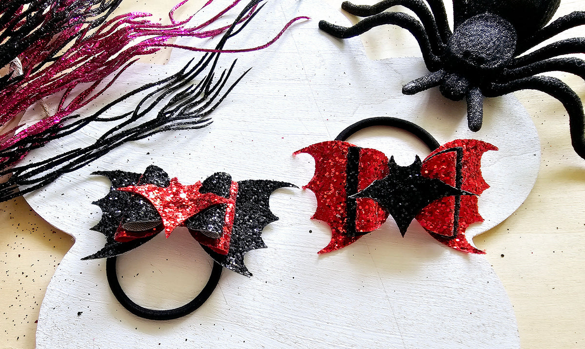 Handmade vampire bat ponytail holder that glows in the dark for spooky season outfits.