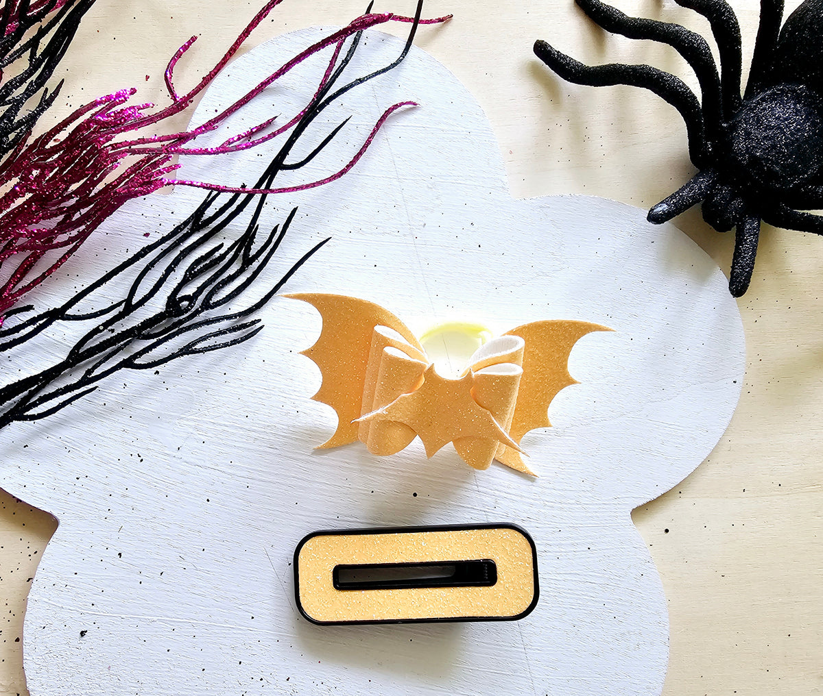 Glow in the dark vampire bat ponytail holder handmade from faux leather for Halloween hairstyles.