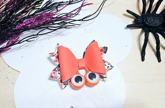 Handmade Halloween hair bow featuring fun googly eyes and premium faux leather for girls.