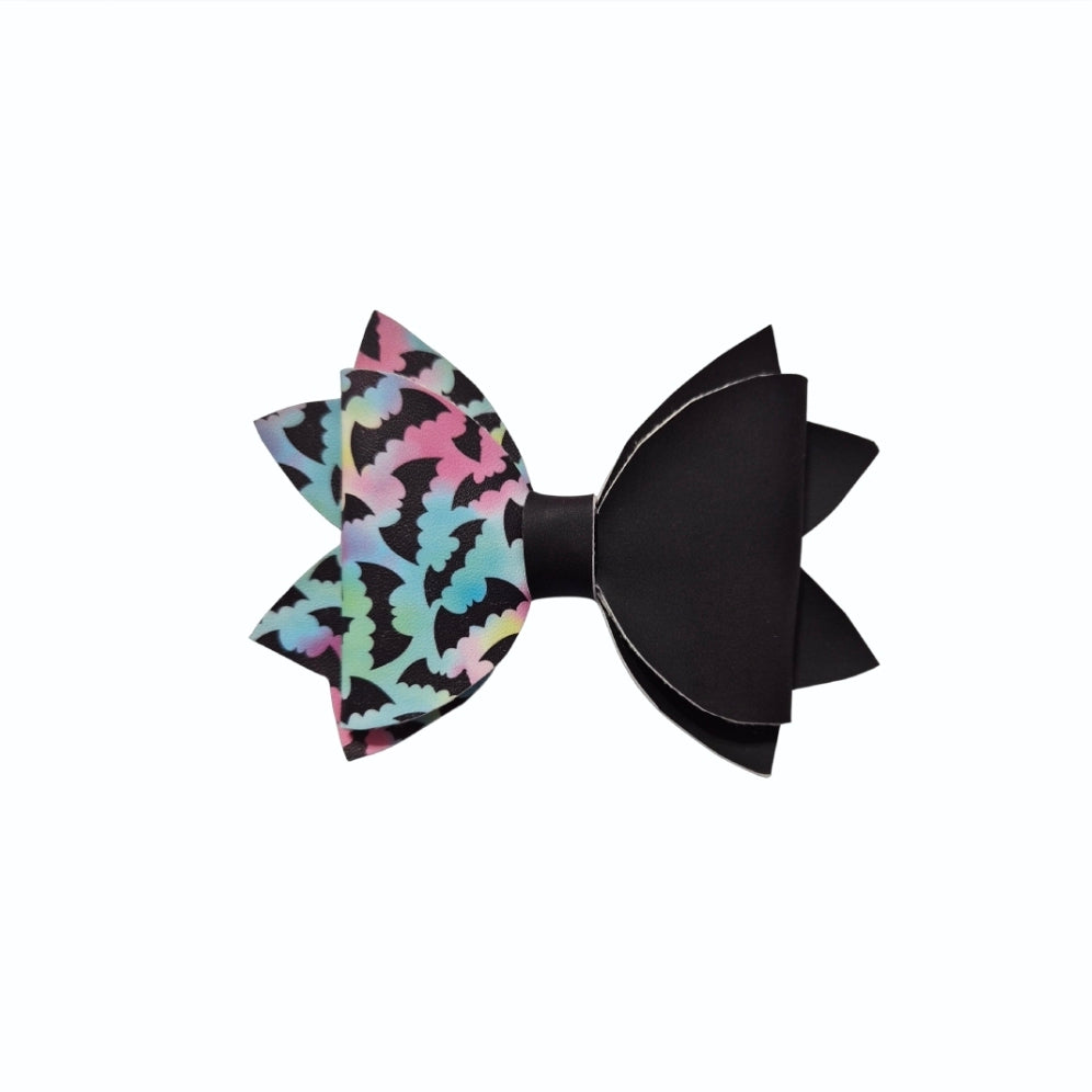 Half and half Halloween bat hair bow featuring pastel heat changing material and solid black faux leather.