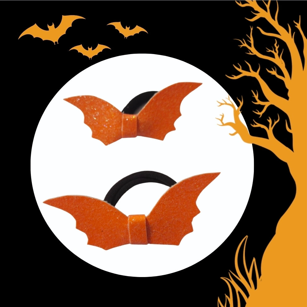 Handmade glitter orange Halloween bat ponytail holder for girls with black elastic hair tie.