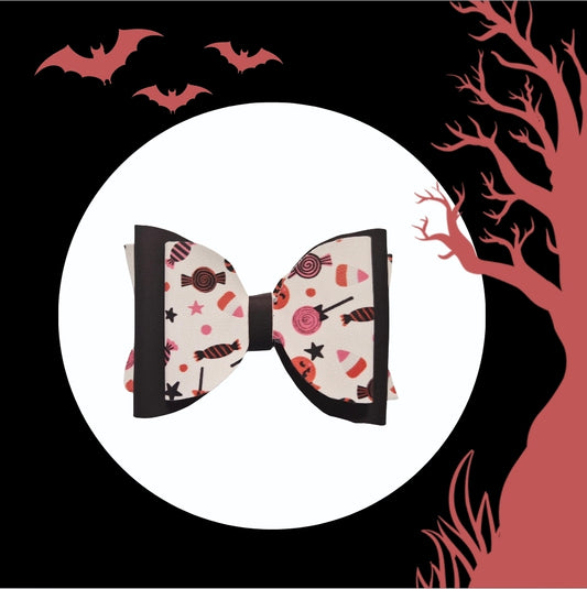 Heat changing Halloween candy hair bow handmade for girls featuring colorful candy print.