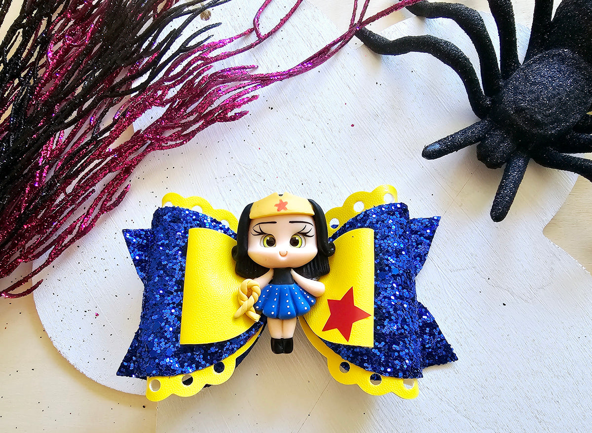 Large handmade Halloween hair bow with detailed costume doll design, perfect for spooky season outfits.