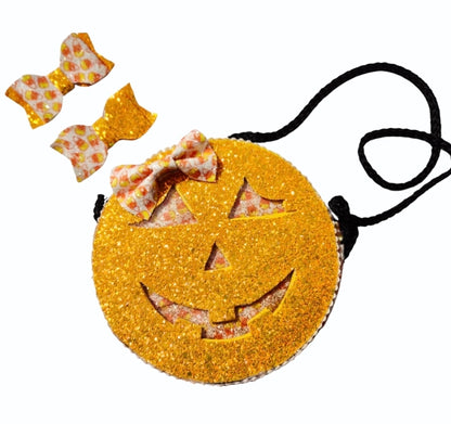 Handmade orange pumpkin crossbody purse with a jack-o'-lantern face for Halloween.