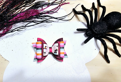 Boutique mini Halloween hair bow for babies and girls with a colorful spooky season design.