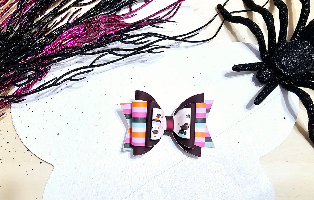 Mini handmade Halloween hair bow featuring heat-changing faux leather, available on an alligator clip or headband.