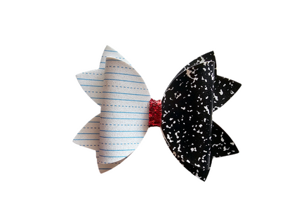 Handmade notebook paper hair bow for girls, perfect for back-to-school outfits, picture day, and everyday school wear.