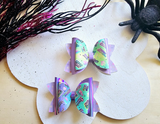 Handmade pastel Halloween mini hair bow set featuring two boutique faux leather bows for girls.