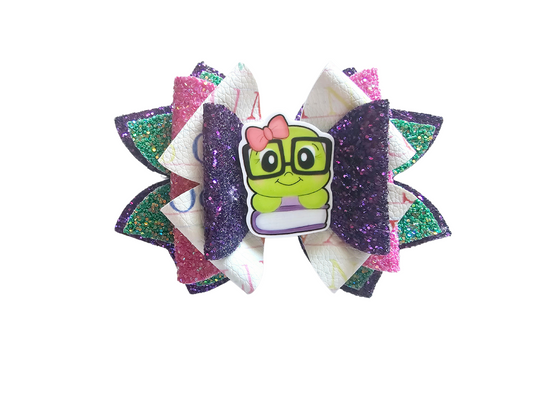 Handmade bookworm hair bow with glitter faux leather layers for girls, perfect for back-to-school outfits, picture day, and young readers.  