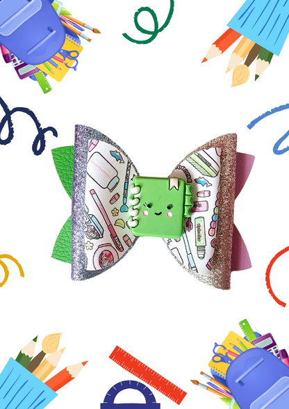 Handmade school supplies hair bows made from faux leather featuring colorful classroom designs, perfect for girls' back-to-school outfits.