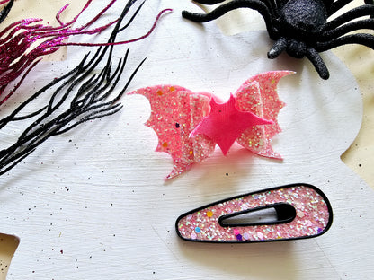 Handmade vampire bat ponytail holder that glows in the dark for spooky season outfits.