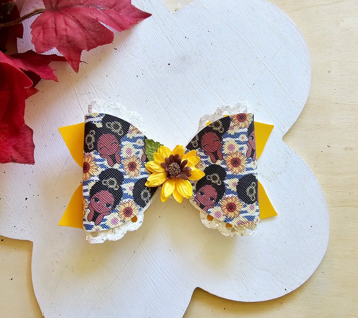 Handmade Sunflower Sweetie faux leather boutique hair bow featuring a sunflower centerpiece for babies, toddlers, and girls.