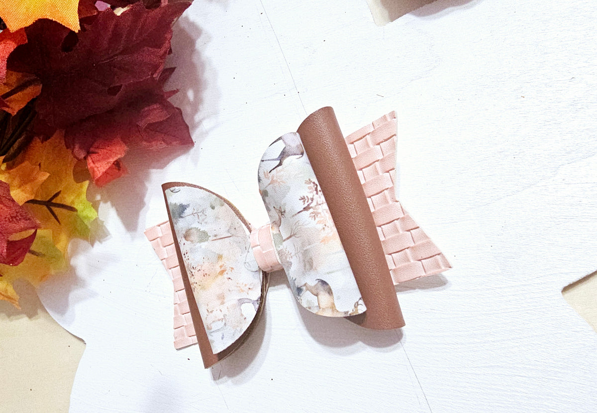Handmade watercolor deer faux leather boutique hair bow with soft woodland colors for girls.