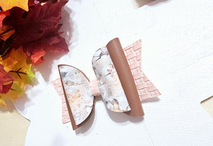 Handmade watercolor deer faux leather boutique hair bow with soft woodland colors for girls.