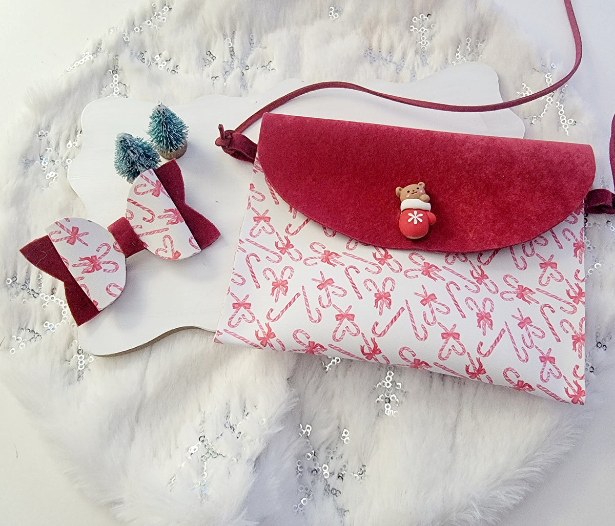 Christmas accessory bundle featuring a red-and-white peppermint print purse and two coordinating holiday hair bows.