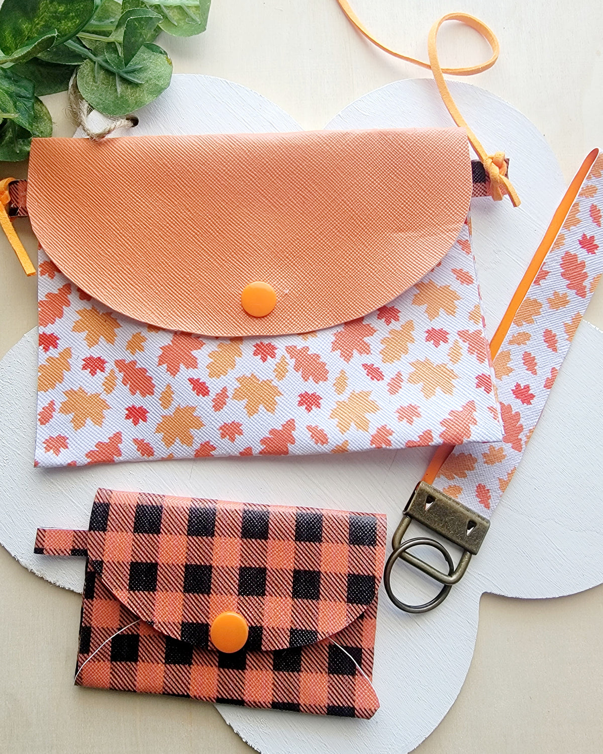 Matching girls' fall purse with colorful leaf print, orange flap, plaid wallet and coordinating wristlet.