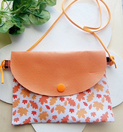 Girls' handmade fall accessory bundle with orange autumn leaf purse and matching orange plaid hair bows.