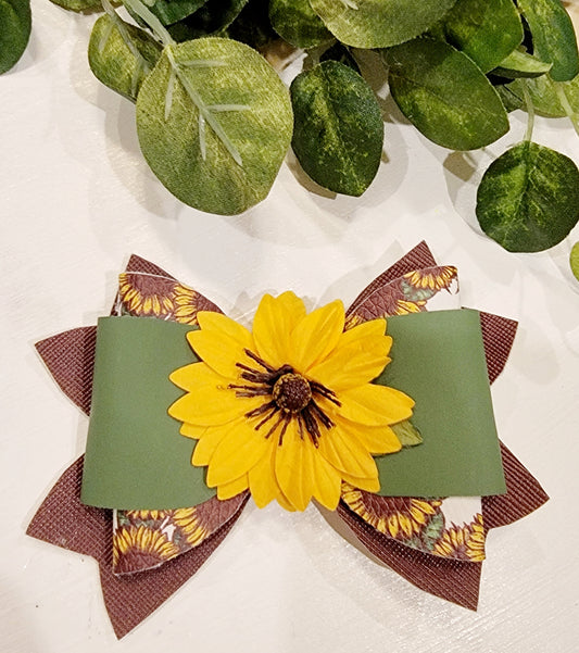 Handmade girls' sunflower hair bow with a large yellow flower, sage green ribbon and layered brown fall accents.